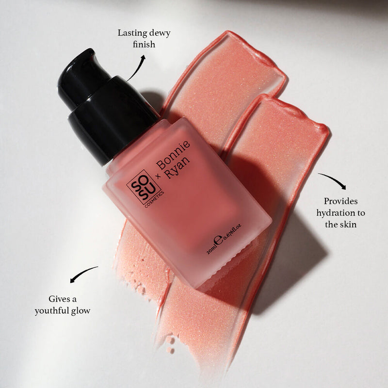 Close-up view of SOSU x Bonnie Ryan Liquid Blush bottle in sunlit ambiance, displaying its shimmering soft pink blush alongside swatches, highlighting features like its lasting dewy finish, ability to give a youthful glow, and skin hydration benefits.
