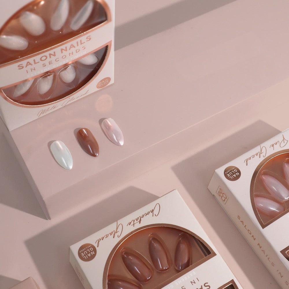 A set of Milk Glazed Nails from SOSU Cosmetics, offering salon quality nails in seconds with a high gloss, glazed chrome effect and a slenderizing stiletto shape.