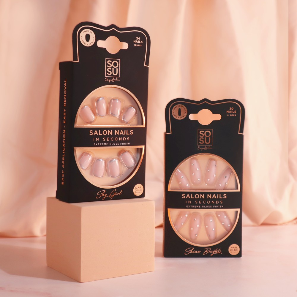 Shine Bright nail set with a classic nude color and jewel accents, in Ballerina shape and medium length. The set includes 24 nails in 12 sizes, with an extreme gloss finish, adhesive, mini nail file, and manicure stick for easy application and removal.