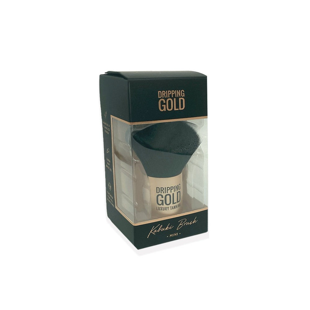 The Dripping Gold Mini Kabuki Brush, a luxurious travel-sized tool for flawless application and blending of face tan and bronzing powder