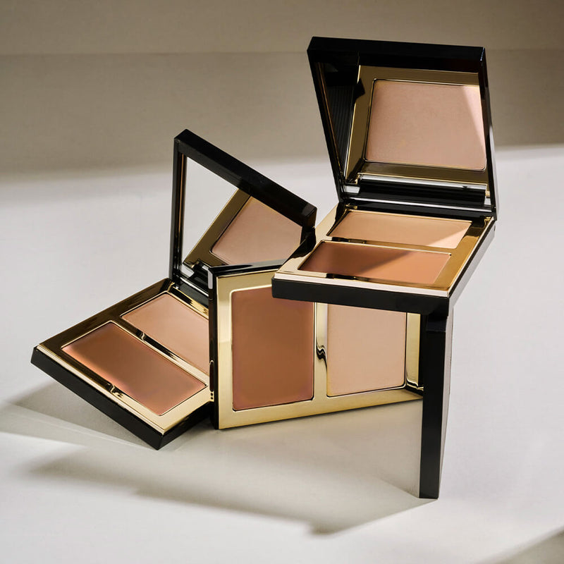Elegant display of the SOSU x Bonnie Ryan Contour & Glow Palettes, capturing their sleek black and gold design. The open palettes reveal lustrous bronze and champagne shades, exemplifying the perfect blend of sophistication and functionality for modern makeup aficionados.