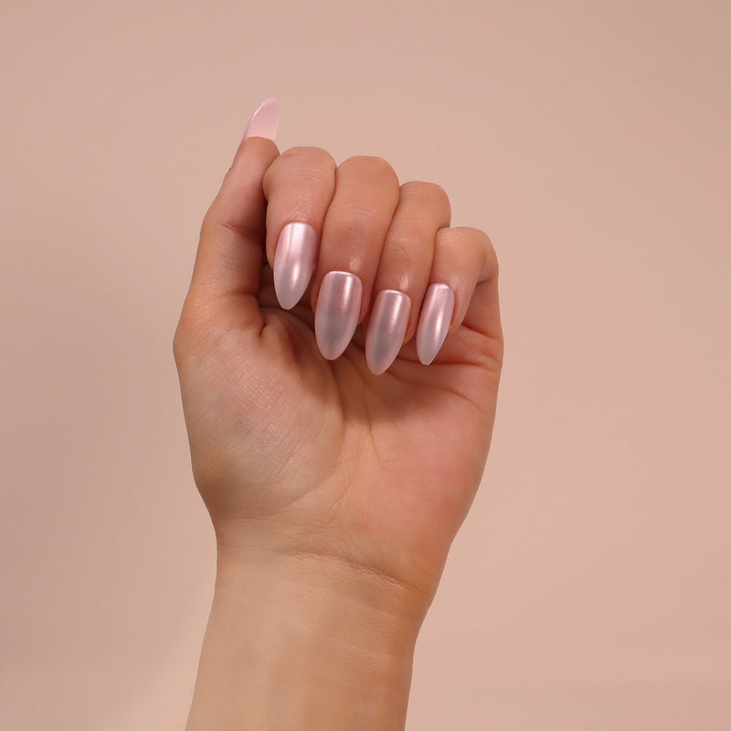 High gloss, glazed pink chrome effect nails in stiletto shape from SOSU Cosmetics, offering salon-quality nails in seconds