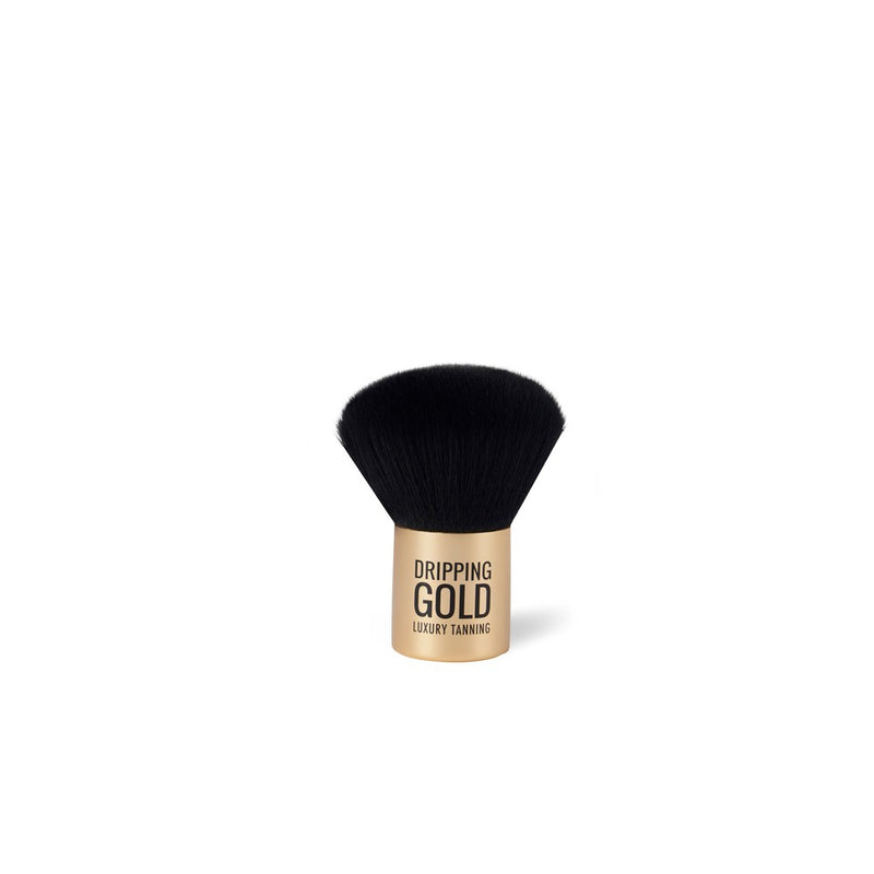 The Dripping Gold Mini Kabuki Brush, a perfect tool for applying and blending face tan and bronzing powder, featuring dense, luxurious, and anti-bacterial synthetic bristles for a flawless finish