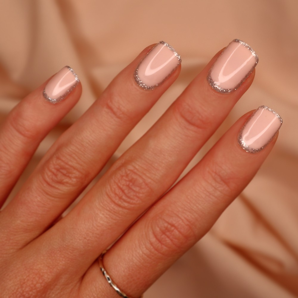 Shy Girl nails in classic nude with a silver accent, square shape, short length, perfect for adding a sparkle to your look this festive season